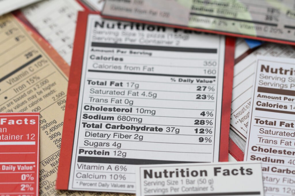 Person comparing emergency food product labels and specifications Product nutrition labels